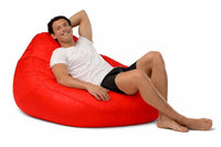 man sitting on a bright red adult bean bag chair