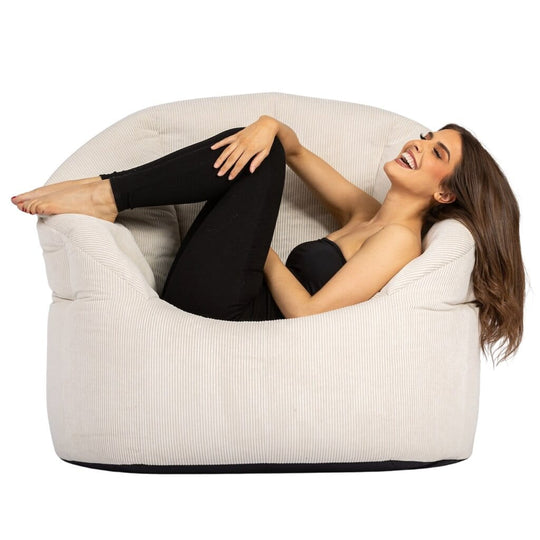 lady laying across a vanilla corduroy tub bean bag chair