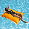 Woman lying on a yellow pool float in a pool