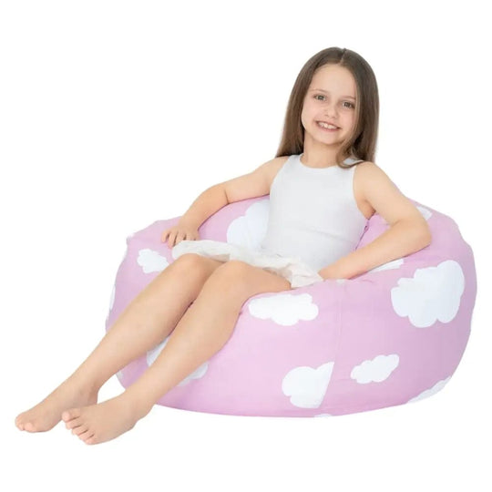 Young girl sitting on a round pink beanbag chair with cloud patterns against a white background