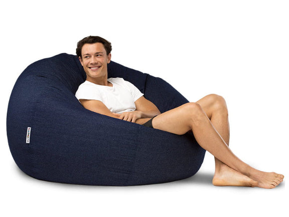 man sitting on a blue denim bean bag