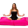 lady doing yoga pose on pink beanbag