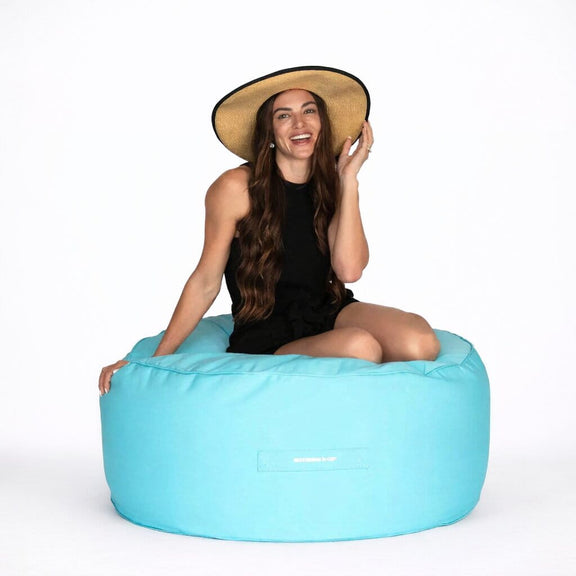 lady posing on a capri blur round outdoor ottoman